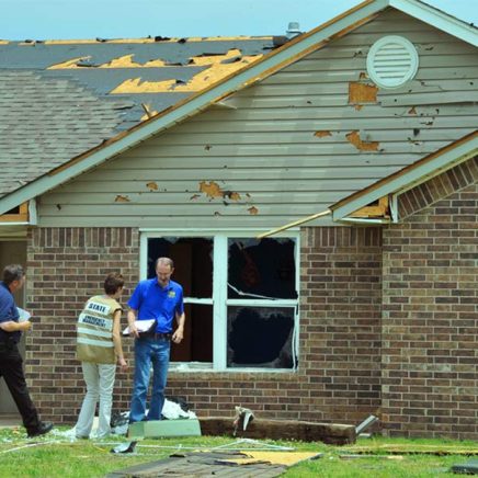 insurance agent assessing house damage after a tornado